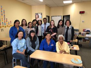 Anna poses with her staff in her center