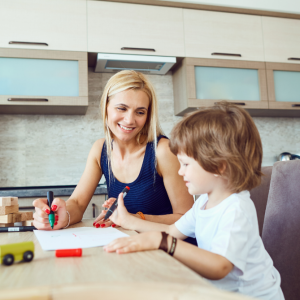 mother in kitchen helping son with worksheet