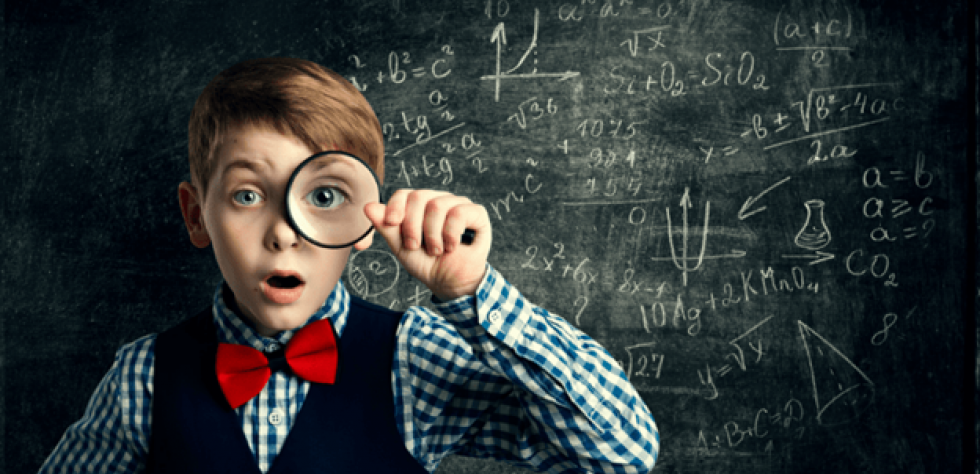 Kid looking through magnifying glass