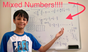 a young boy stands in front of a white board filled with math problems