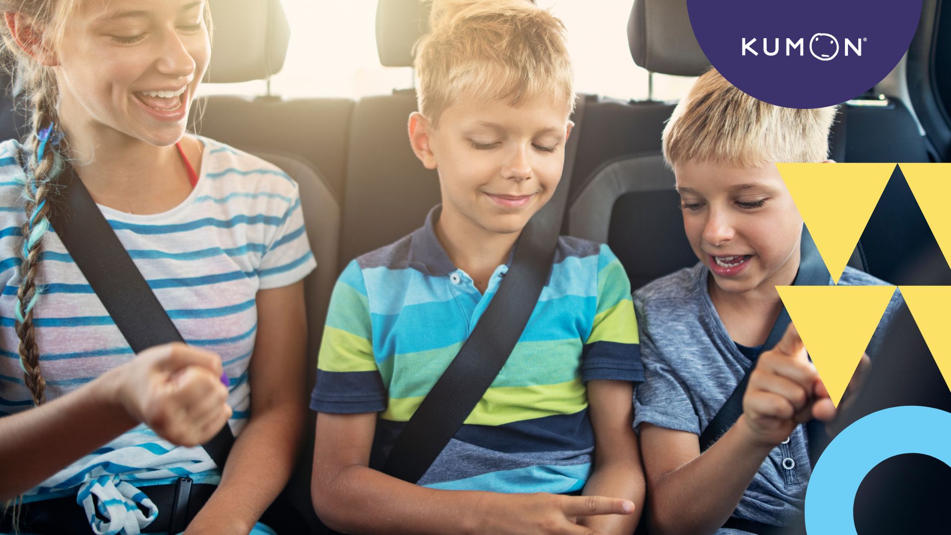 three kids in a backseat playing a game