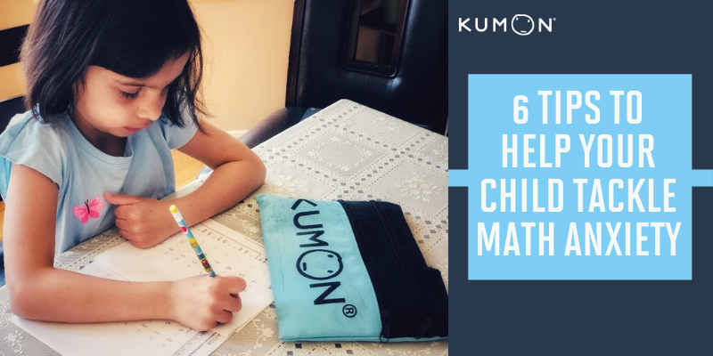 a young girl sitting at a table next to her pencil pouch working on her math worksheet