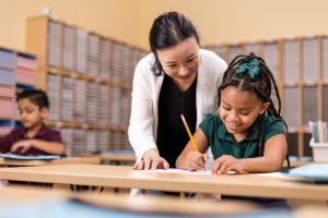 Instructor helping student.