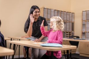 Instructor helping student.