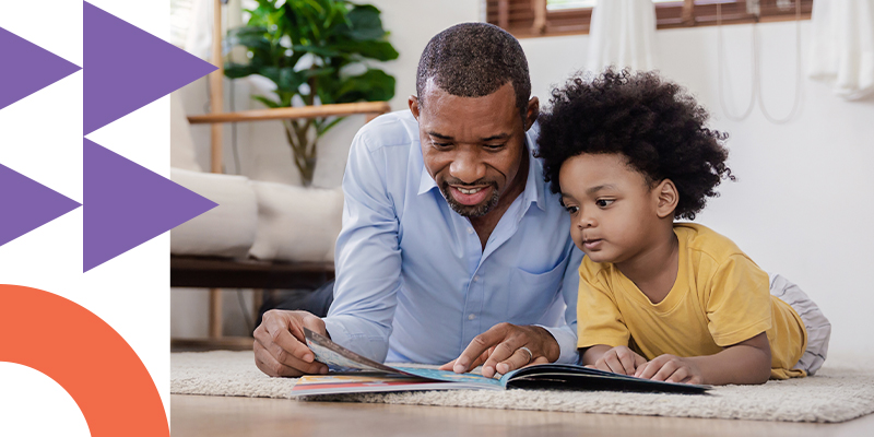 Father reading to his son in the living room