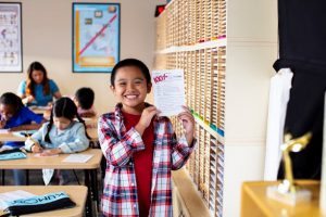 Student holding up grade