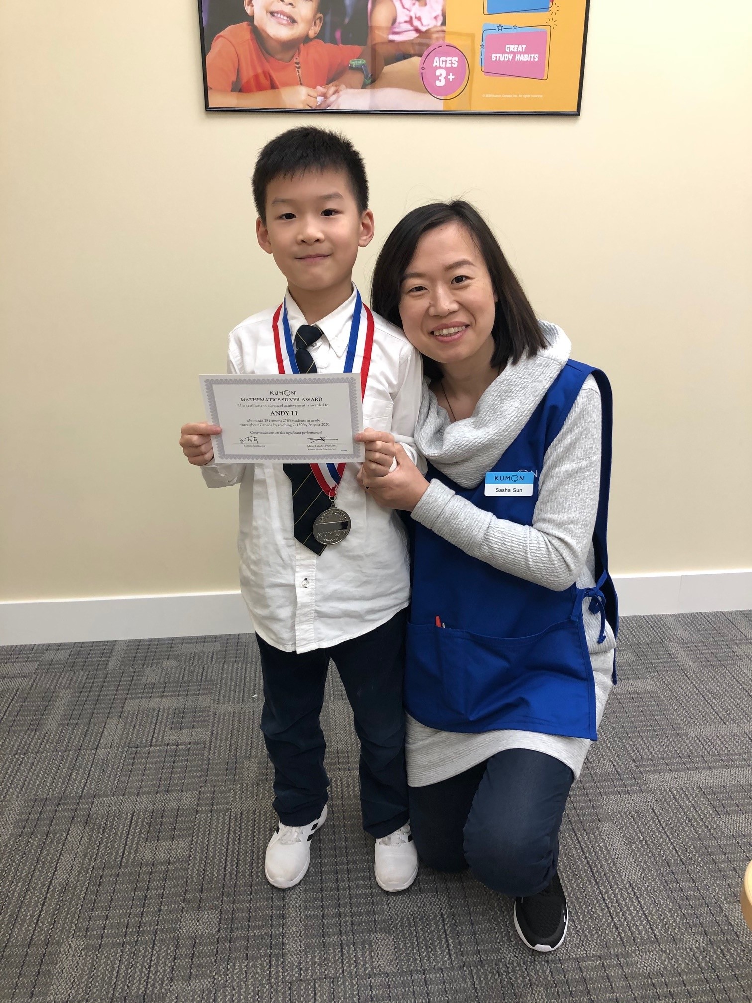 Sasha standing with student