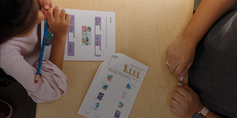 Instructor helping student with worksheets