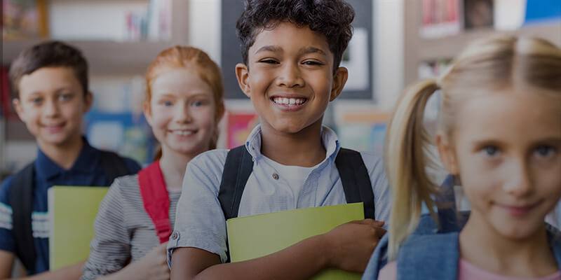 Happy students with book bags