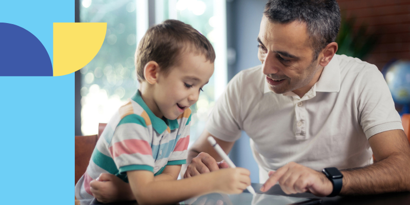 Man helping young boy with lesson
